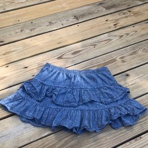Women’s denim ruffle miniskirt with unknown brand.